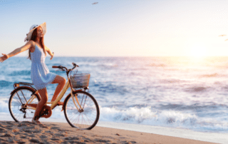 Woman riding a bike on beach