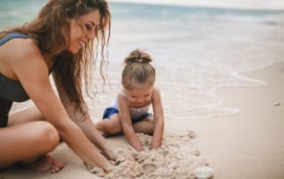 Mom and Daughter playing in sand